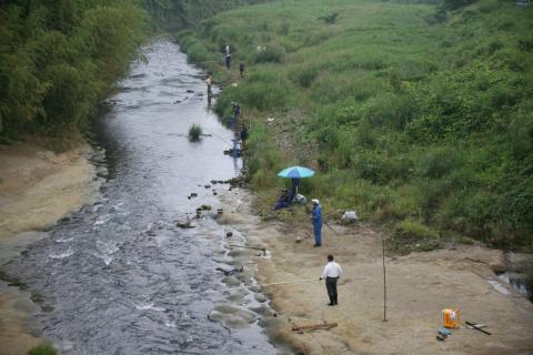 鮎釣りでは、渓流の浅瀬に立ち長い釣り竿を使います