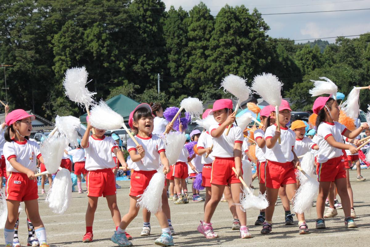 音楽に合わせて楽しそうにポンポンを振る子どもたち