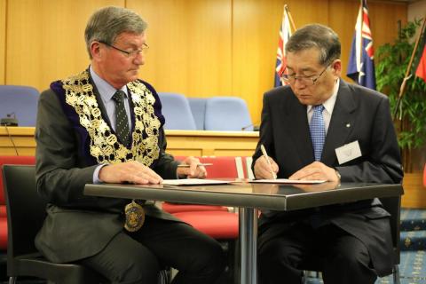 姉妹都市提携に関する協定書に再署名する渡辺町長とラッシ市長