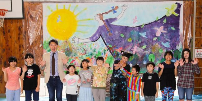 蟹江さんらと巨大絵画の完成を喜ぶ児童