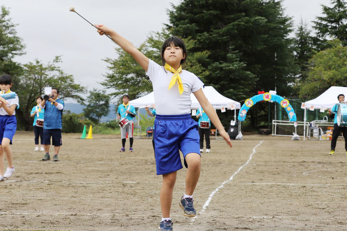 音楽に合わせ華麗なバトンさばきを披露する児童