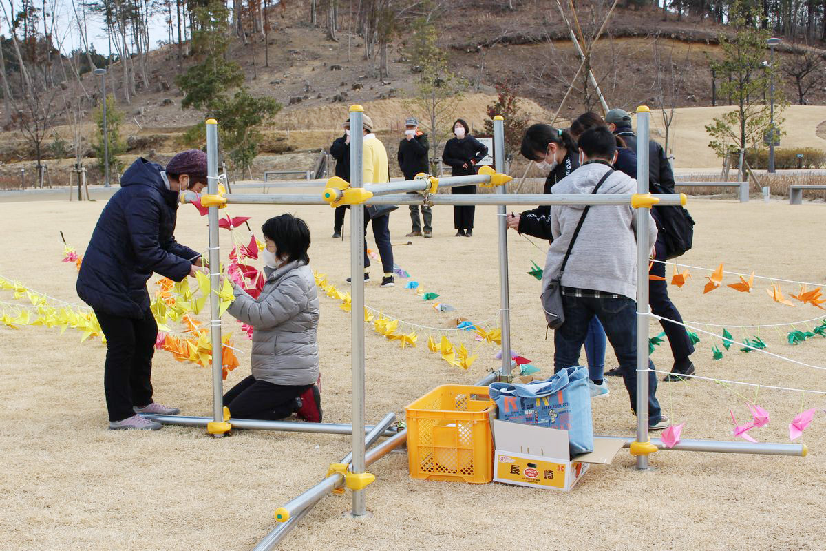 町民らと一緒に追悼イベントの準備を手伝う子ども