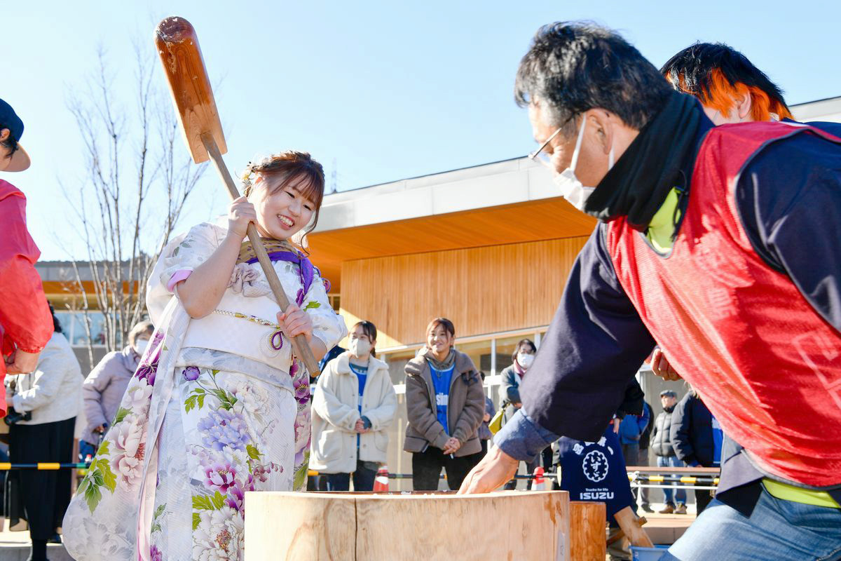 里がえりもちつき大会に参加した二十歳の成人たち。東日本大震災時、小学1年生だった子どもたちが杵を振るう姿に来場者らも笑顔を見せました。