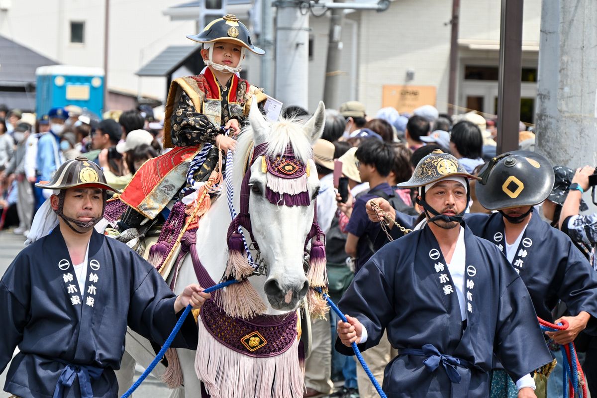 観客が見守る中、堂々と行列に参加する初陣を飾った騎馬隊