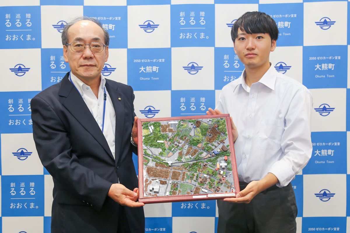 島副町長にジオラマを手渡す熊谷さん（右）