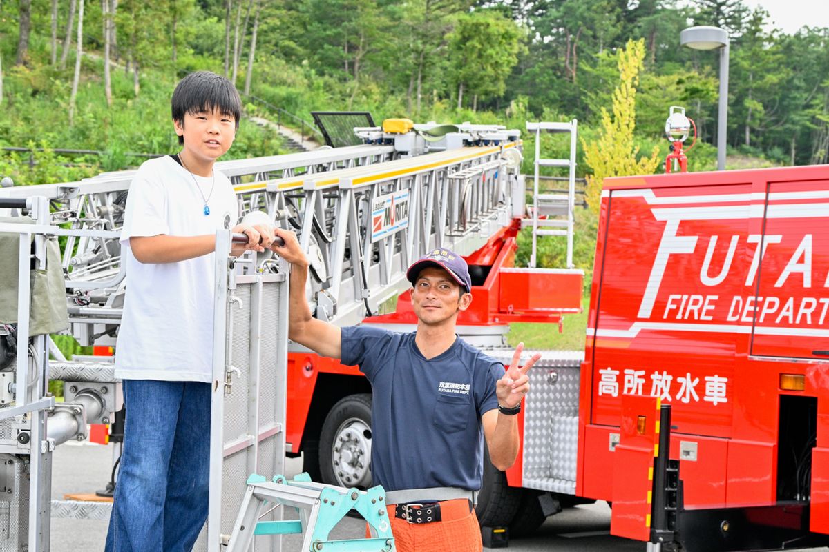 はたらくクルマコーナーには、双葉警察署、郵便局、富岡消防署の車両が展示されました。普段はじっくり見ることができない車両の内部や装備について説明を受け、気になる質問をするなど興味深く見学していました。写真は梯子車に乗る子ども。