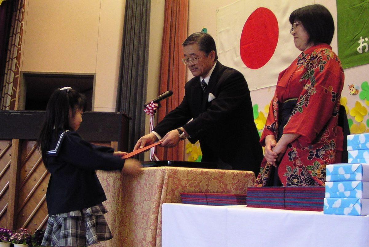 少し緊張した表情で園長先生から終了証書を受け取る卒園児