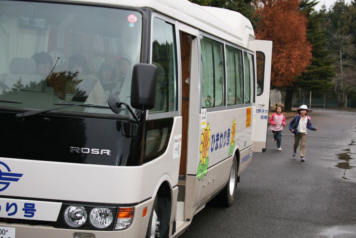 移動図書館車に向かって走る児童たち