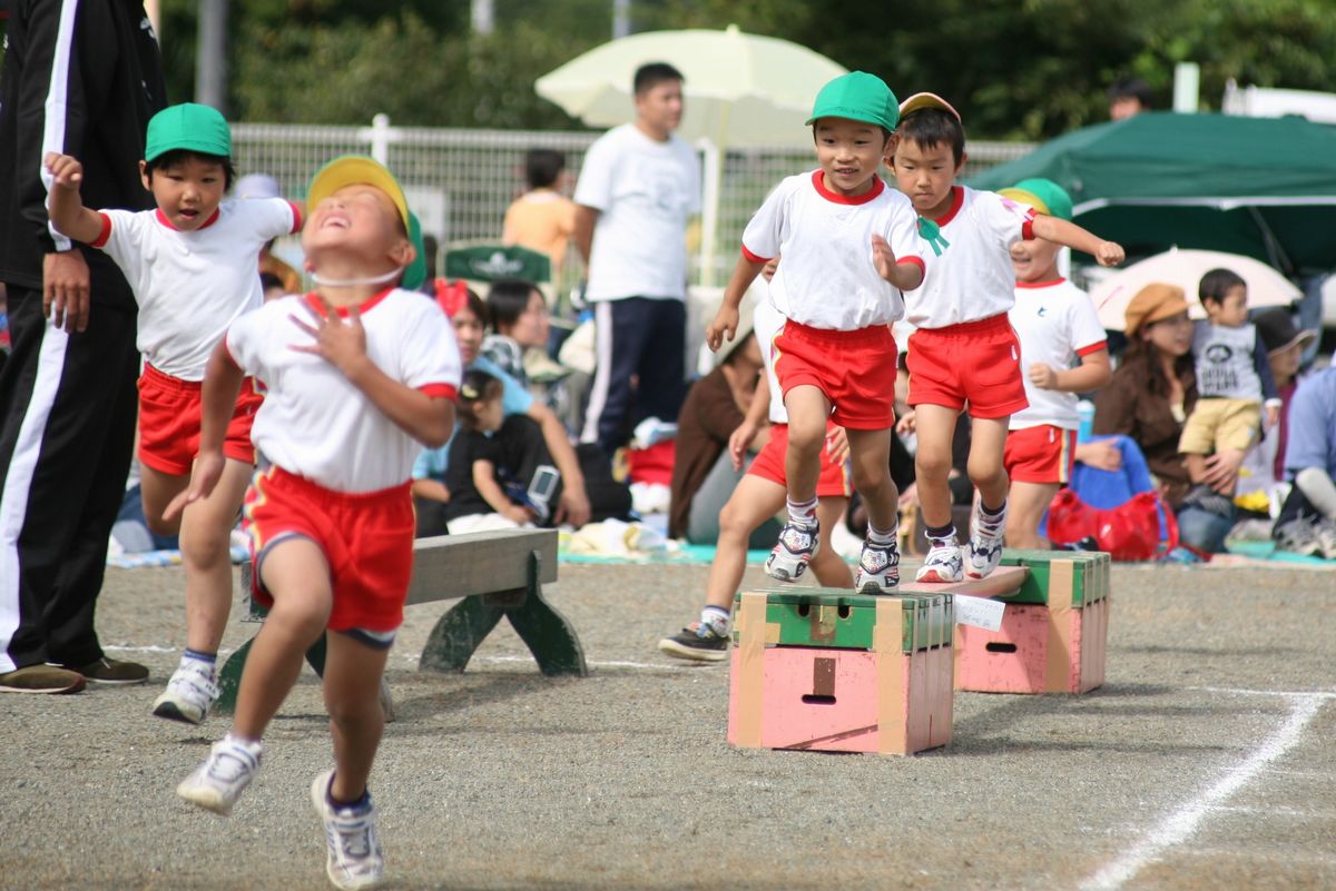 障害物を乗り越え夢中でゴールに向かい走る園児