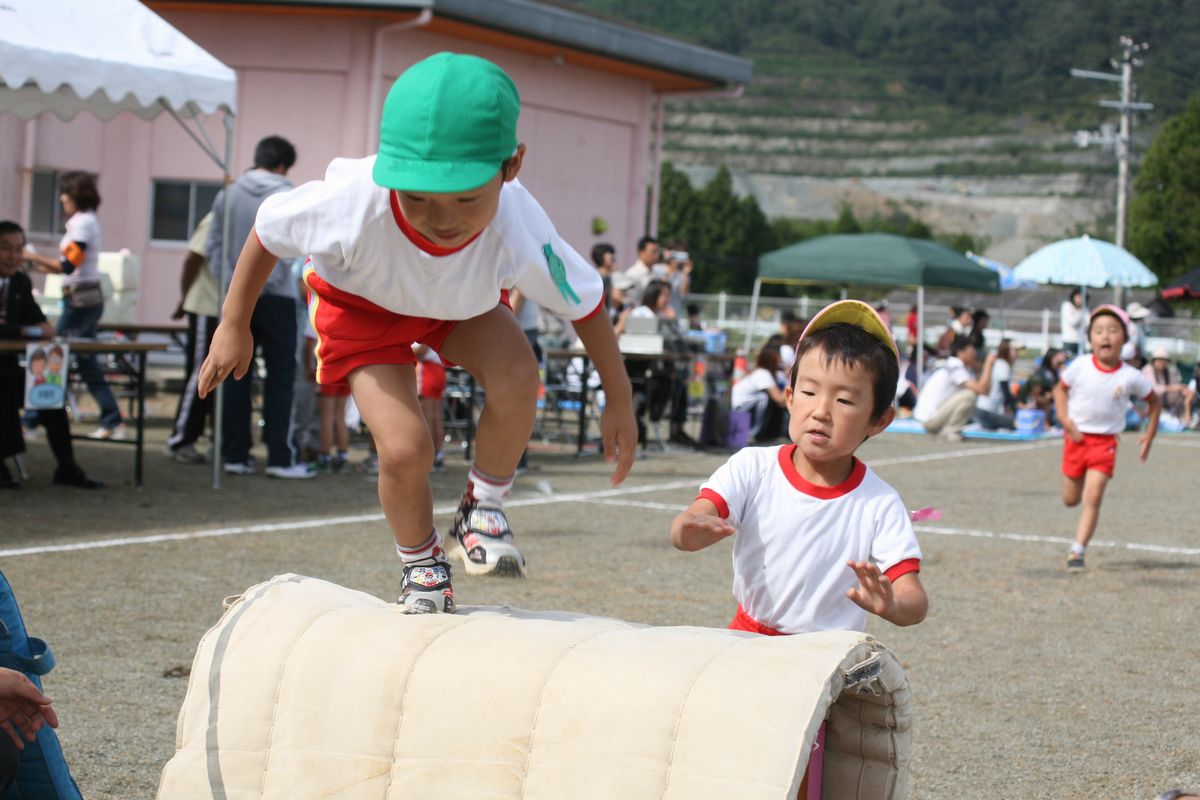 障害物を勢いよく跳び越えゴールを目指す園児